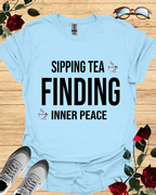 Sipping Tea Finding Inner Peace – Relaxed T-Shirt in Long & Short Sleeve Styles Printify